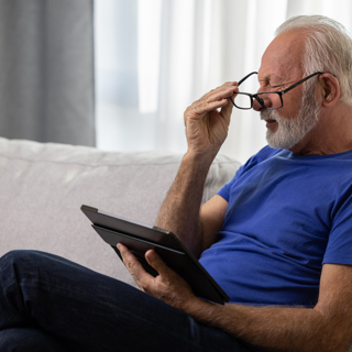Optical Elderly Man Struggling To Read (2)