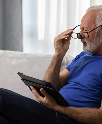 Optical Elderly Man Struggling To Read (2)